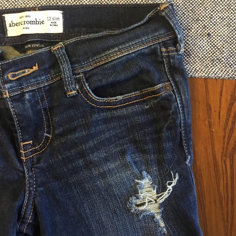 Abercrombie Kids stretch girls’ distressed jeans.